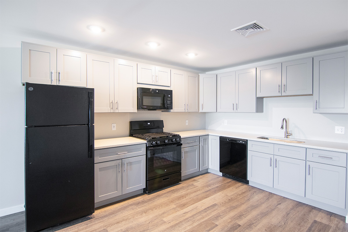 A Kitchen with White Cabinets and a Black Refrigerator